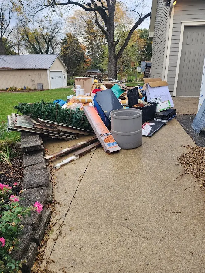 Dumpster being loaded with debris for Roofing Dumpster Rental in Lee